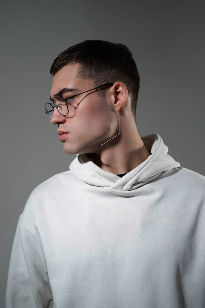 A male model demonstrating chiseled jawline from side